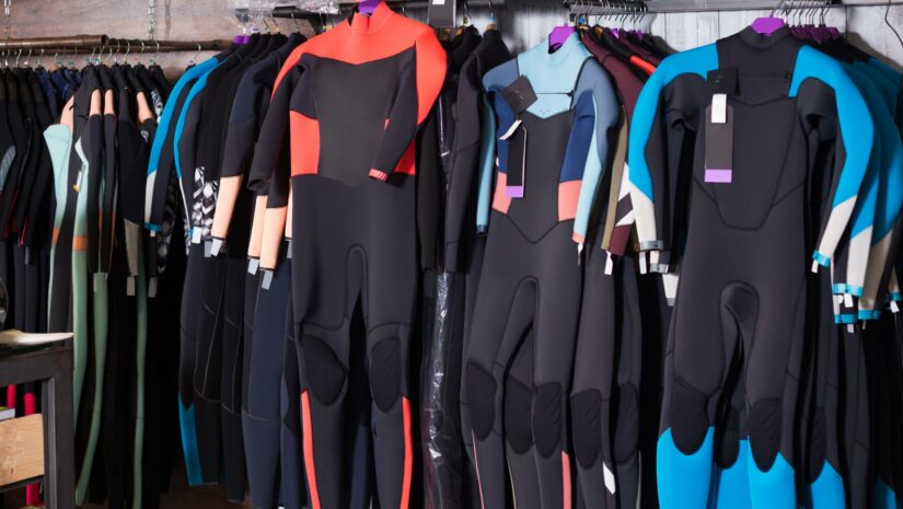colorful wetsuits in displayed in a shop