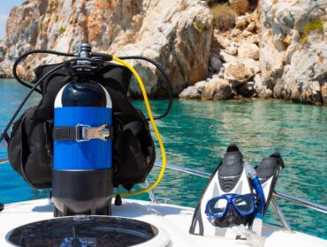 dive tank, fins, mask and snorkel on a boat