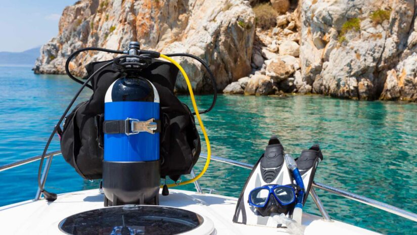 dive tank, fins, mask and snorkel on a boat