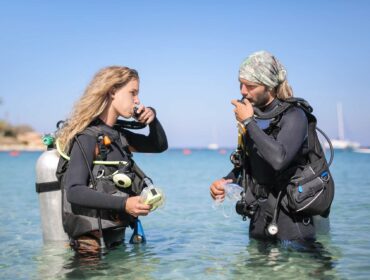 dive buddies checking their air supply
