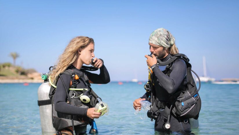 dive buddies checking their air supply