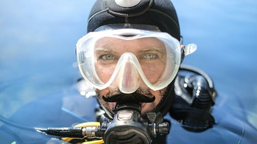 headshot of a scuba diver with a mask and regulator