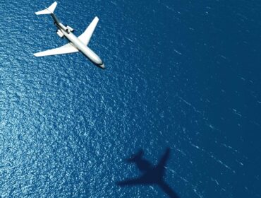 Airplane flying over the ocean