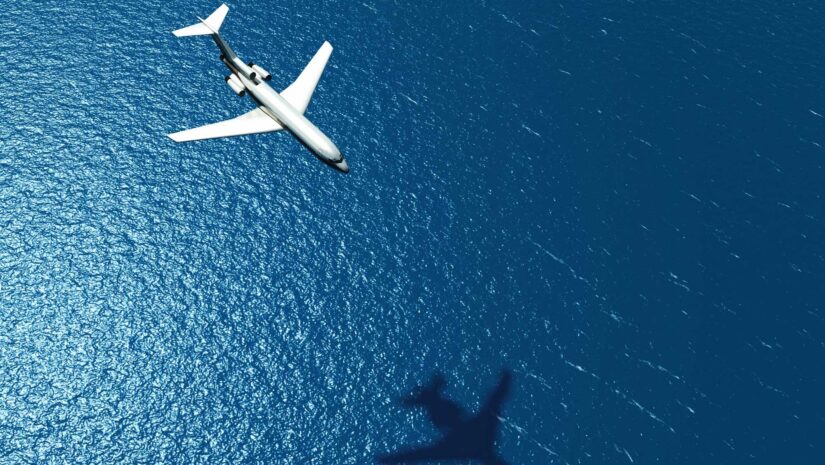 Airplane flying over the ocean