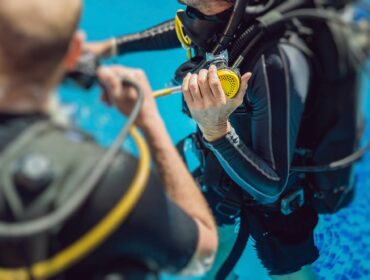 diver holding his scuba regulator