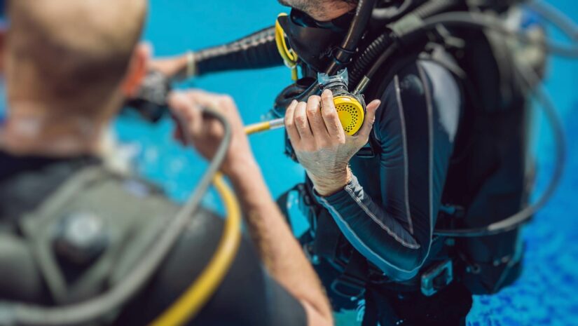 diver holding his scuba regulator