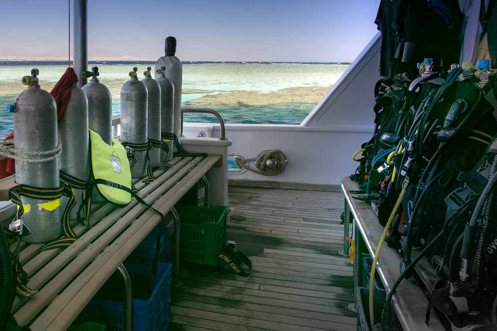 scuba equipment for a group displayed on a boat ready for use