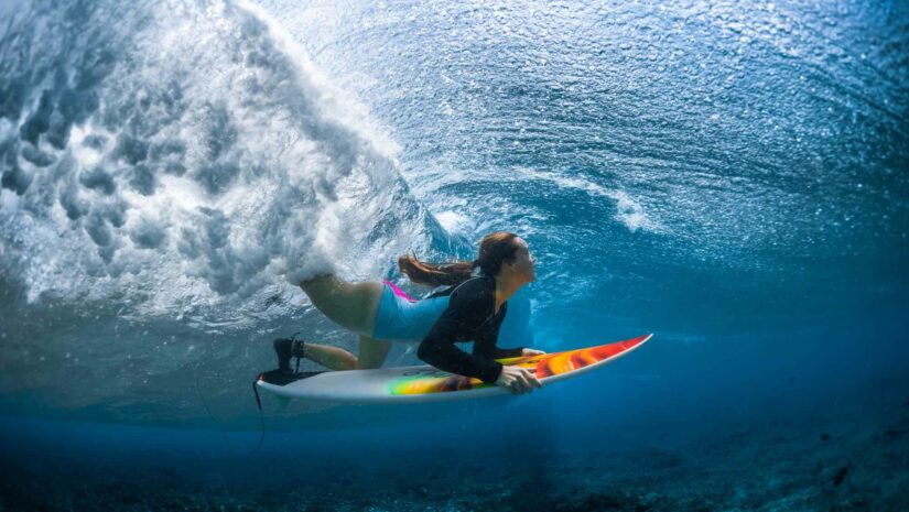 a surfer in a women’s long sleeve rash guard