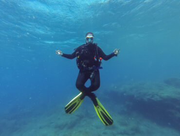 Young female scuba diver in the lotus yoga position during a dive in Atlantic ocean