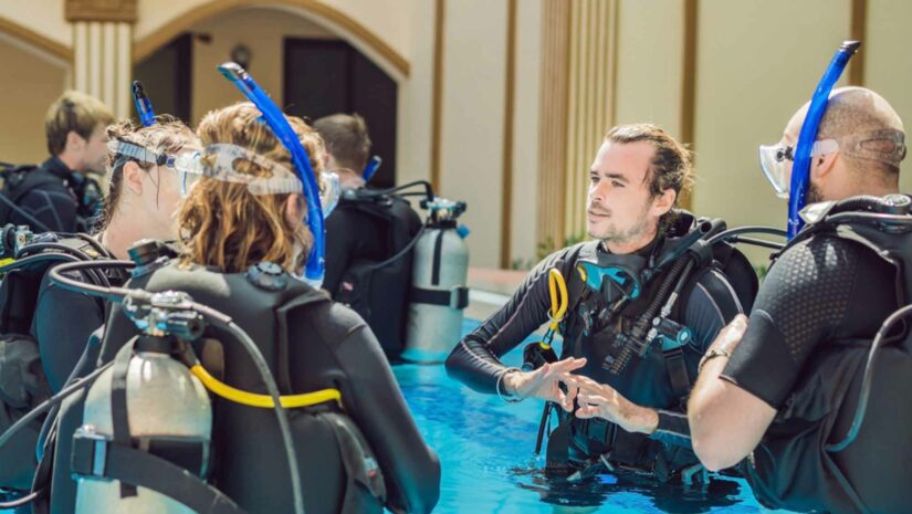diving instructor teaching students