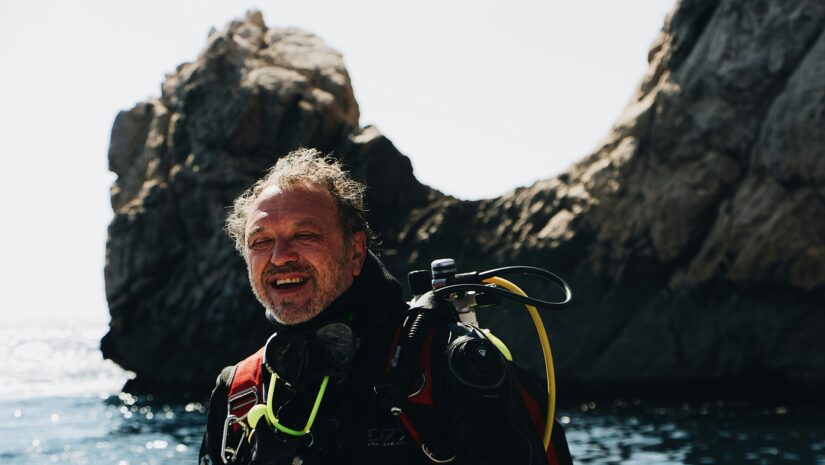 a man wearing his scuba octopus and full dive equipment