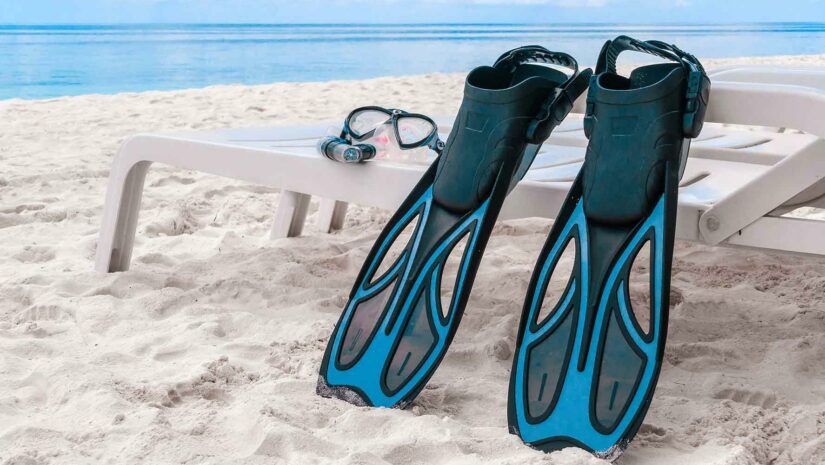 Long open-heeled fins on the beach