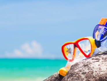 colorful snorkels on a rock at the beach