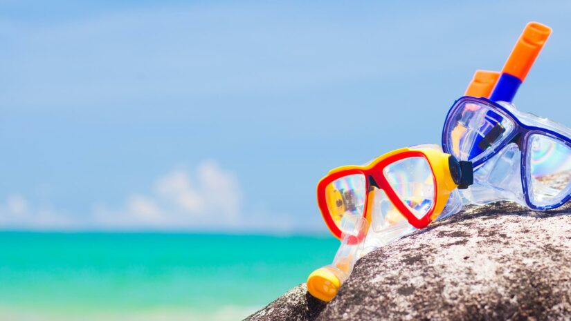 colorful snorkels on a rock at the beach