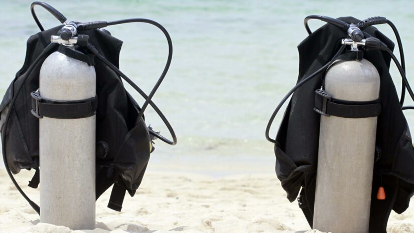 Two scuba tanks on the beach