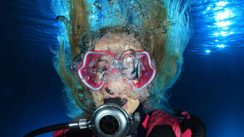 female scuba diver with long unkempt hair