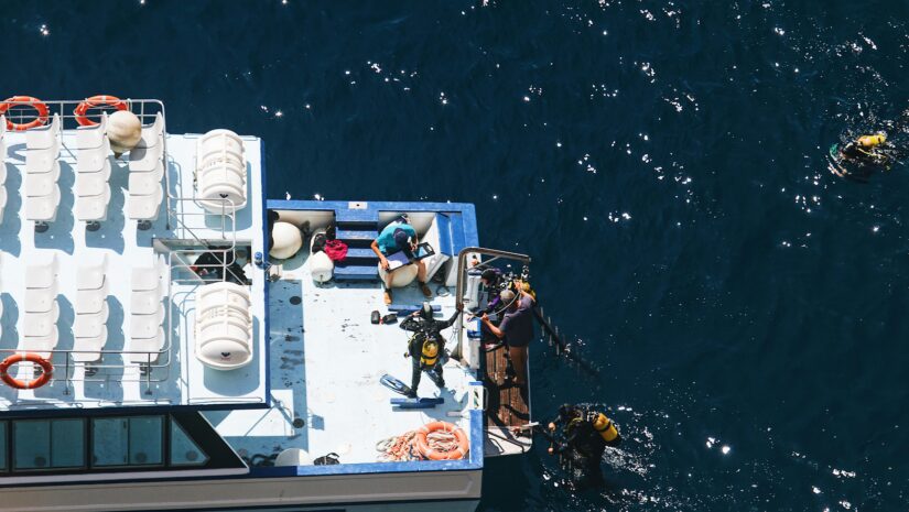 A group of divers disembarking their boat