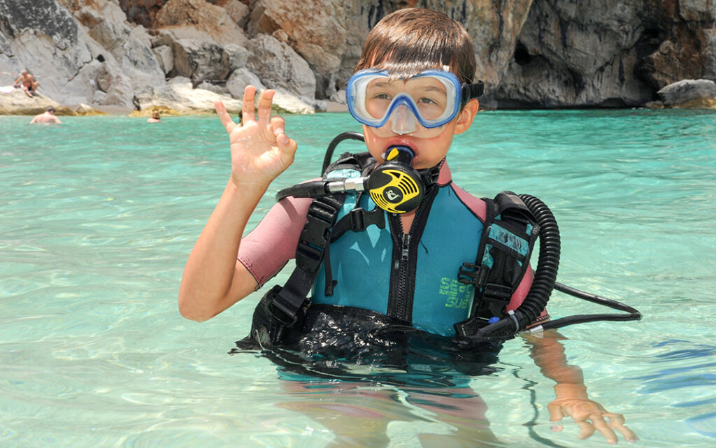 kid discovers scuba diving at Cala Mariolu beach on Sardinia