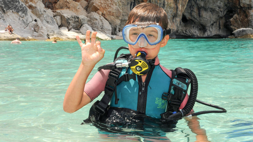 kid discovers scuba diving at Cala Mariolu beach on Sardinia