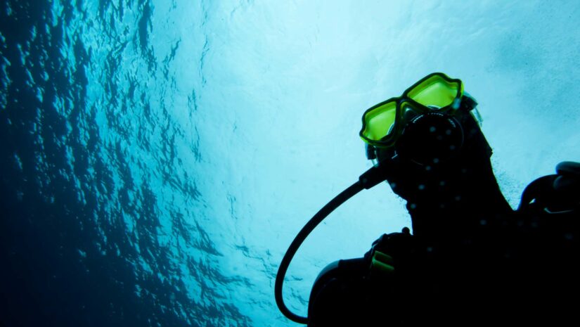 man scuba diving in an indoor swimming pool