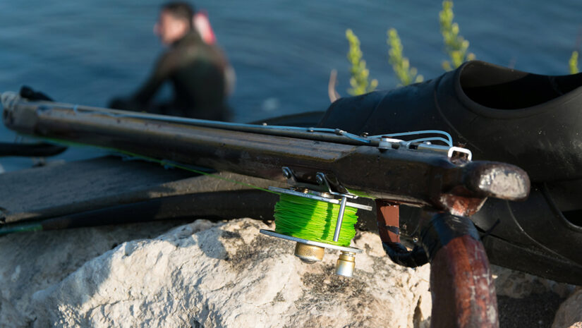 spearfishing gear with a scuba diver in the frame