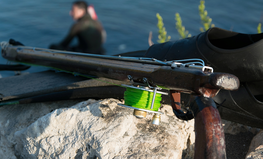 spearfishing gear with a scuba diver in the frame