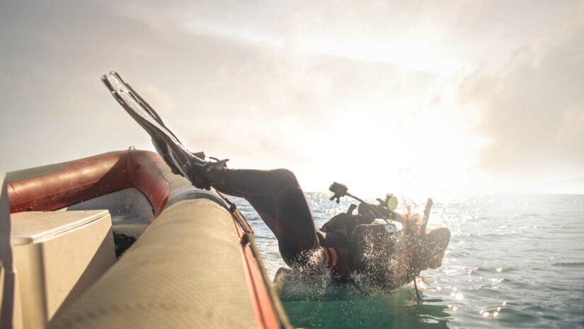 scuba diver executing the back roll