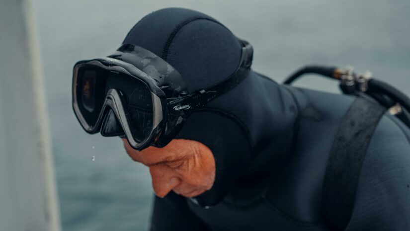 Dry suit diver coming back to surface