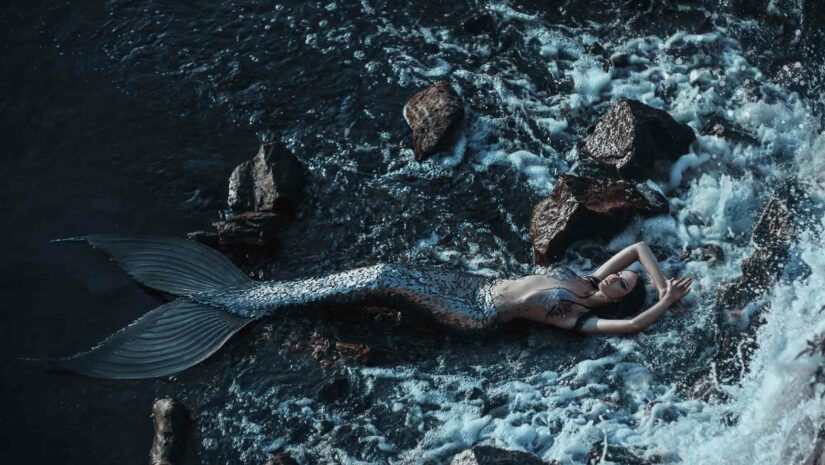 alluring mermaid reclining on the rocks