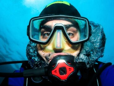 Close up shot of diver in scuba mask underwater
