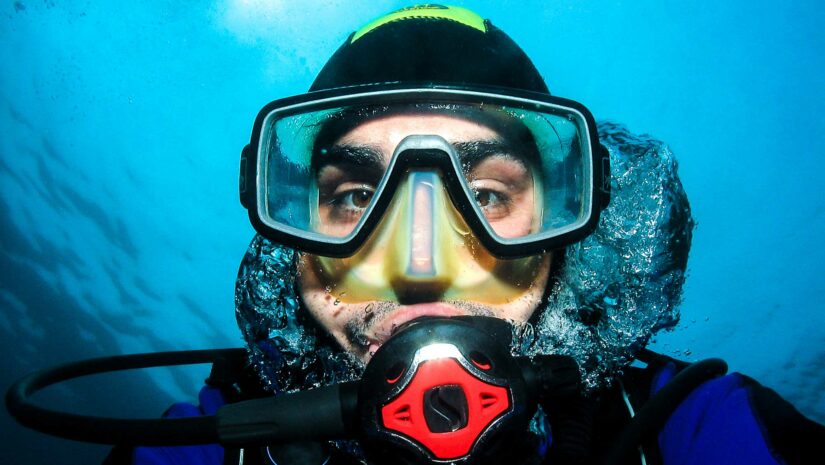 Close up shot of diver in scuba mask underwater