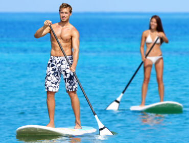 male and female paddle boarders