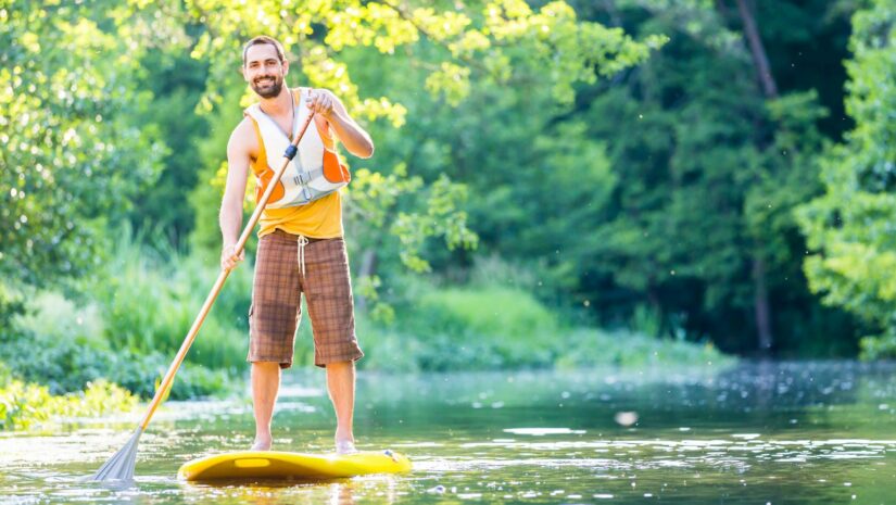 man paddle boarding in the lake