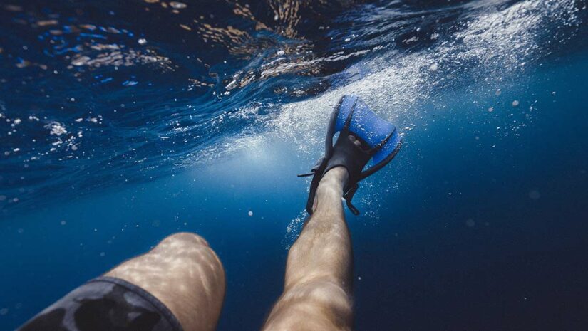 snorkeling fins on snorkeler underwater