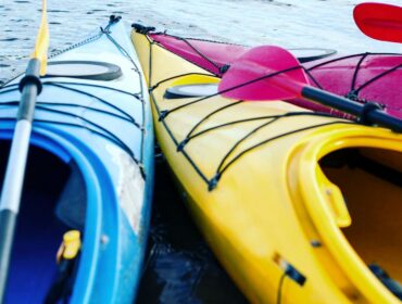 Colorful kayaks side by side in the water