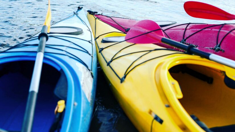 Colorful kayaks side by side in the water