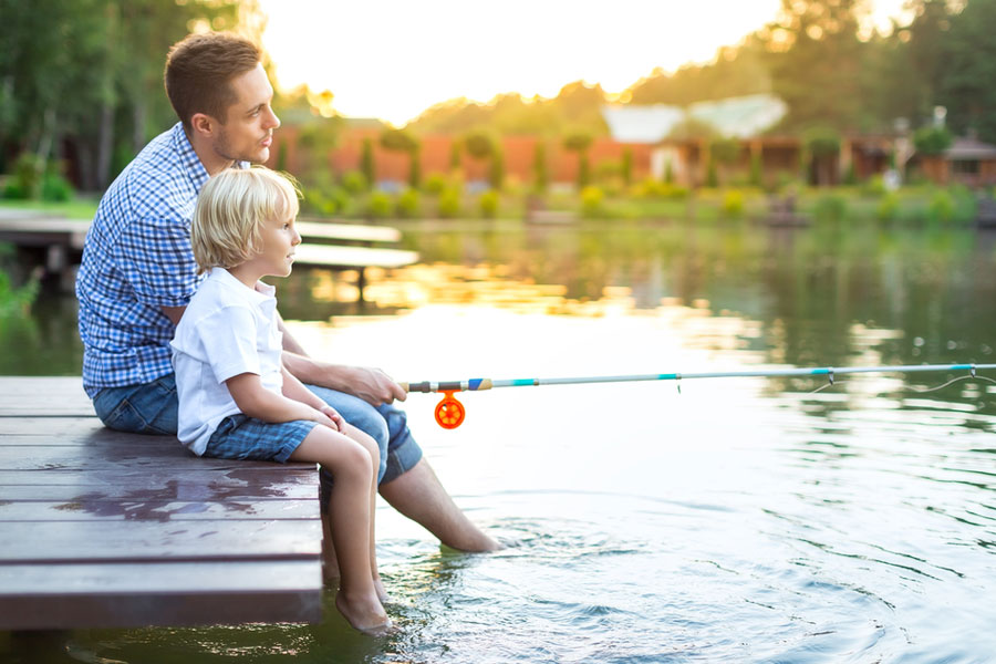man and young boy fishing