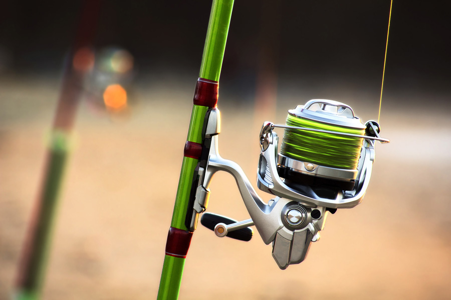 zoomed in shot of fishing line spooled onto fishing reel