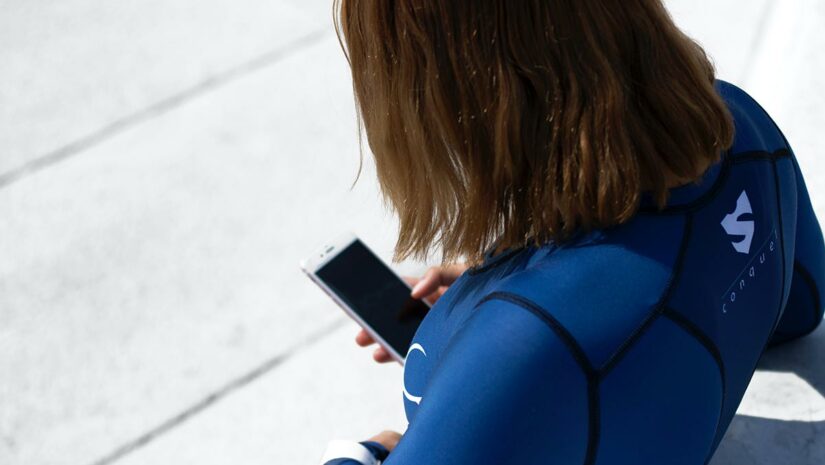 woman wearing wetsuit ready to dive