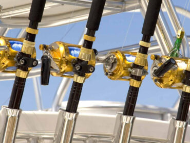 a row of fishing rods set up behind a boat