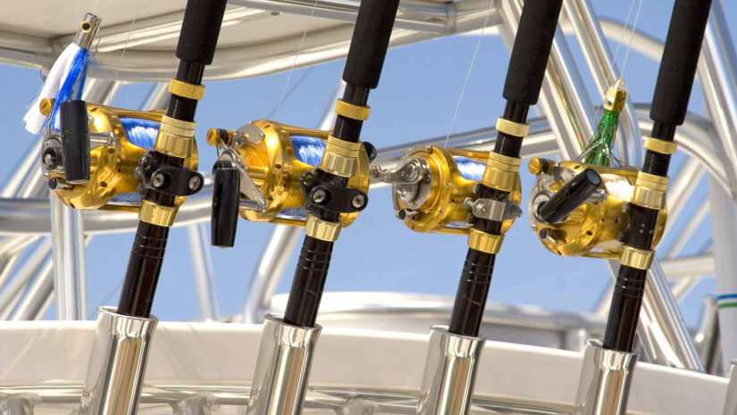 a row of fishing rods set up behind a boat