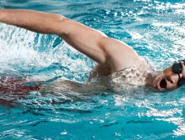 male swimmer inhaling during freestyle stroke