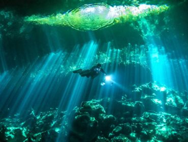 diver exploring a cenote in The Riviera Maya