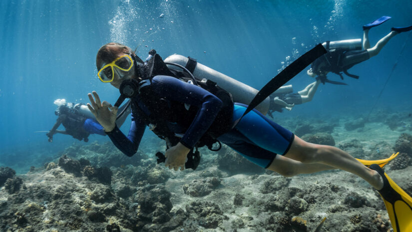 scuba diver making a hand signal