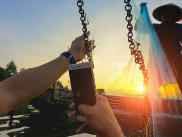 swimmer taking a photo of a fisherman