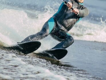 a man water skiing with combo skis