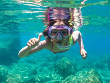 a young girl wearing snorkeling gear