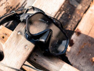 a scuba mask resting on wood