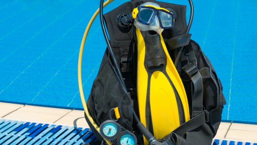 scuba equipment bag with different pieces of diving gear
