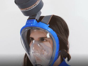 woman wears a modified full-face snorkeling mask from Ocean Reef
